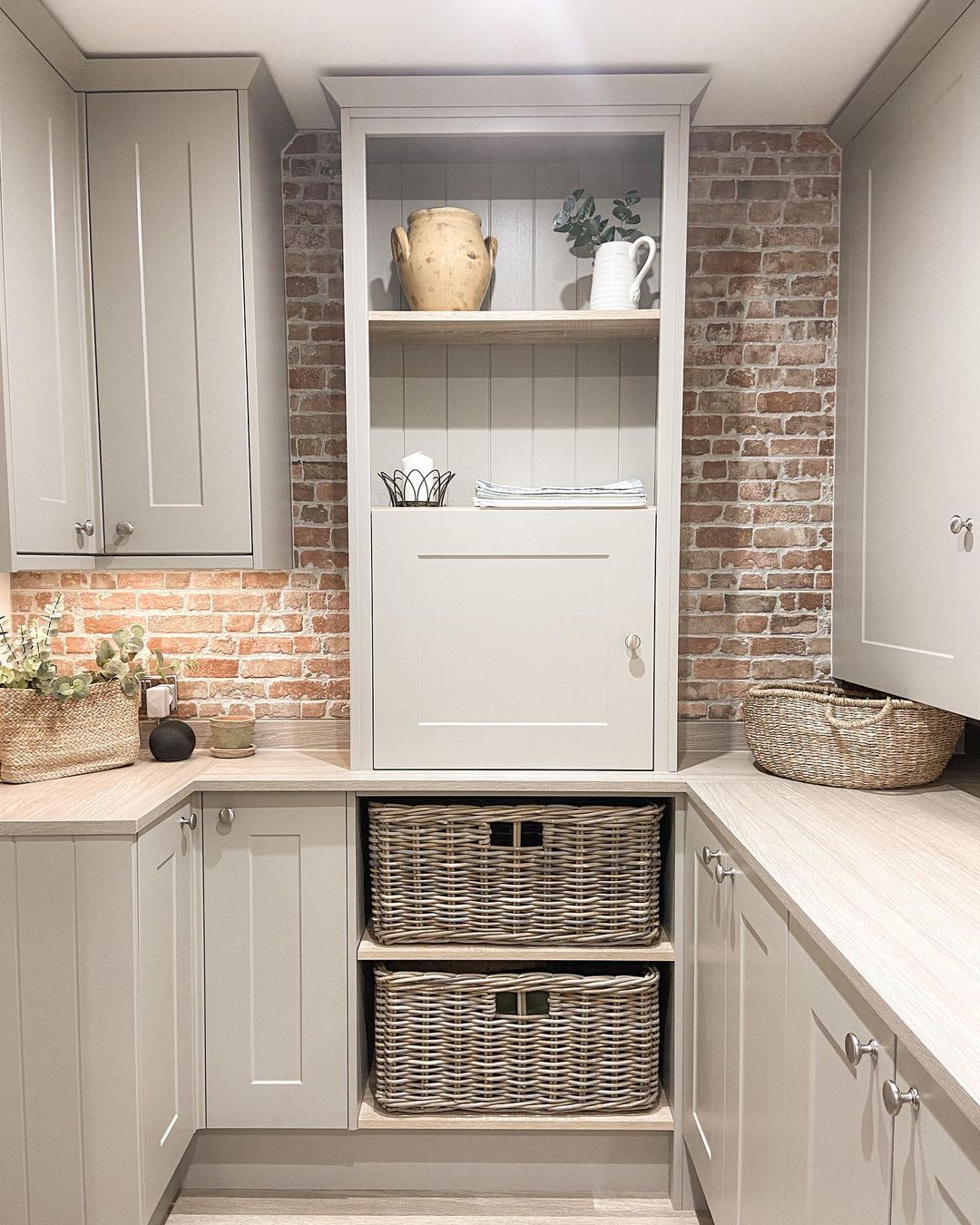 Rattan storage basket neatly fitted into kitchen cabinetry, offering stylish hidden storage for linens, pantry items or household essentials.