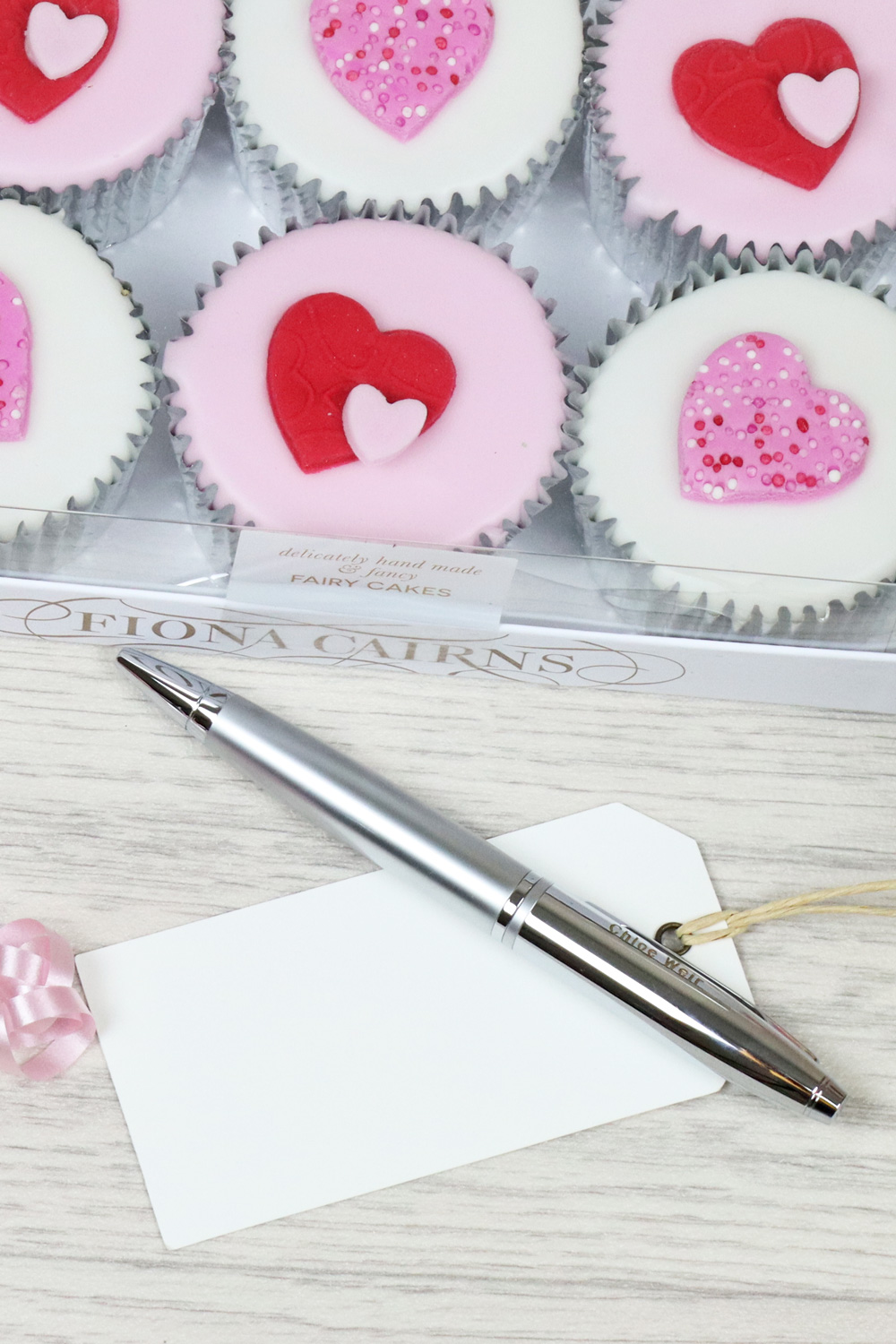 a tray of heart cupcakes and white gift tag.