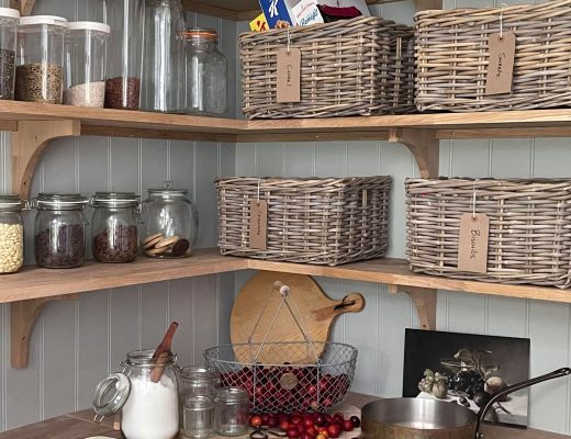 a rustic farmhouse kitchen with wicker food baskets
