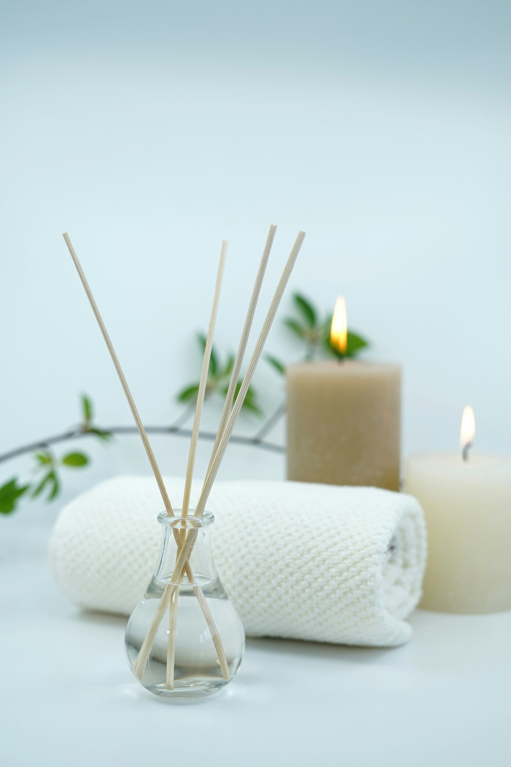 a peaceful spa setting with reed diffuser and candles