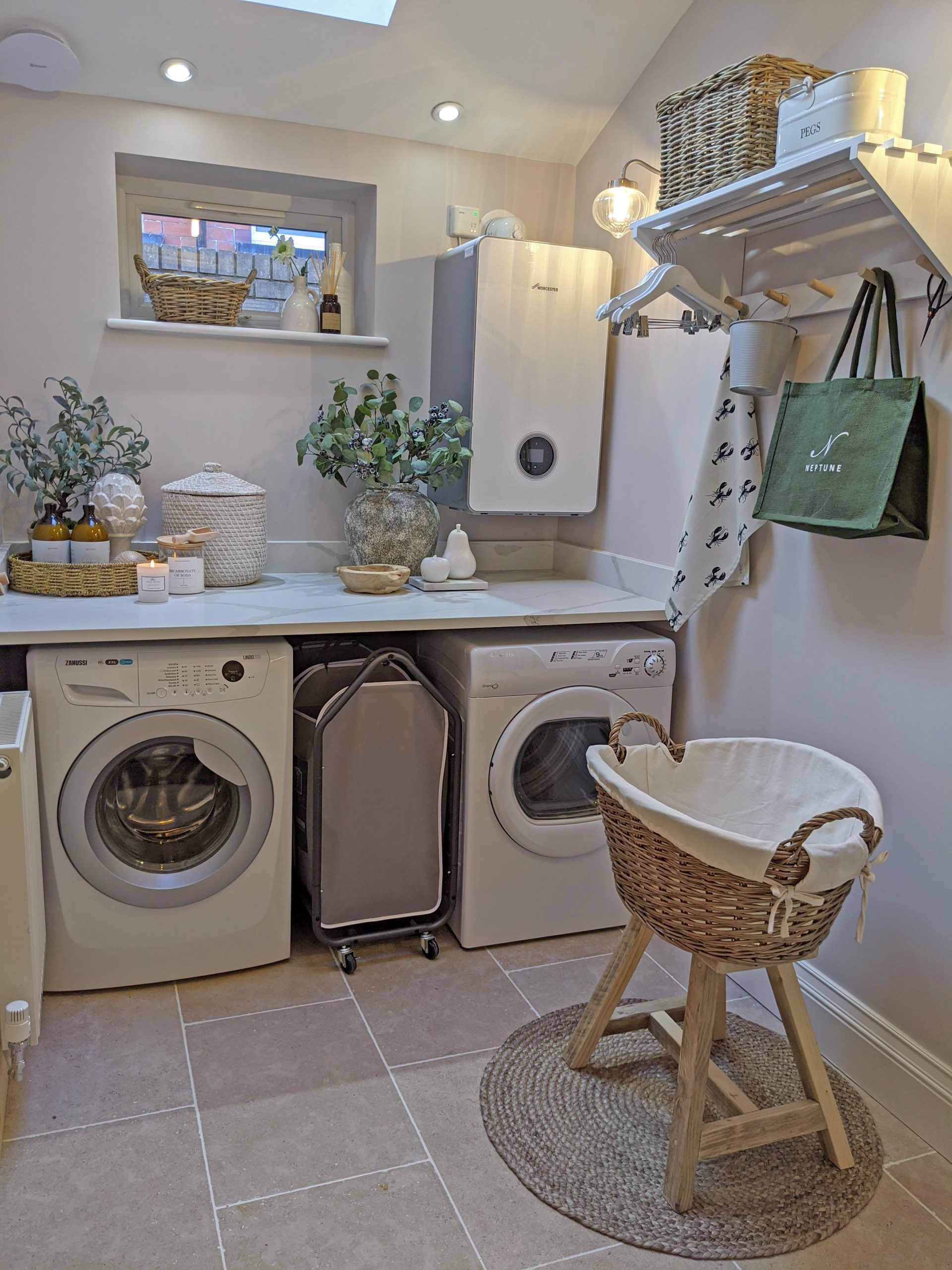 A beautifully styled utility room with a grey wicker washing basket