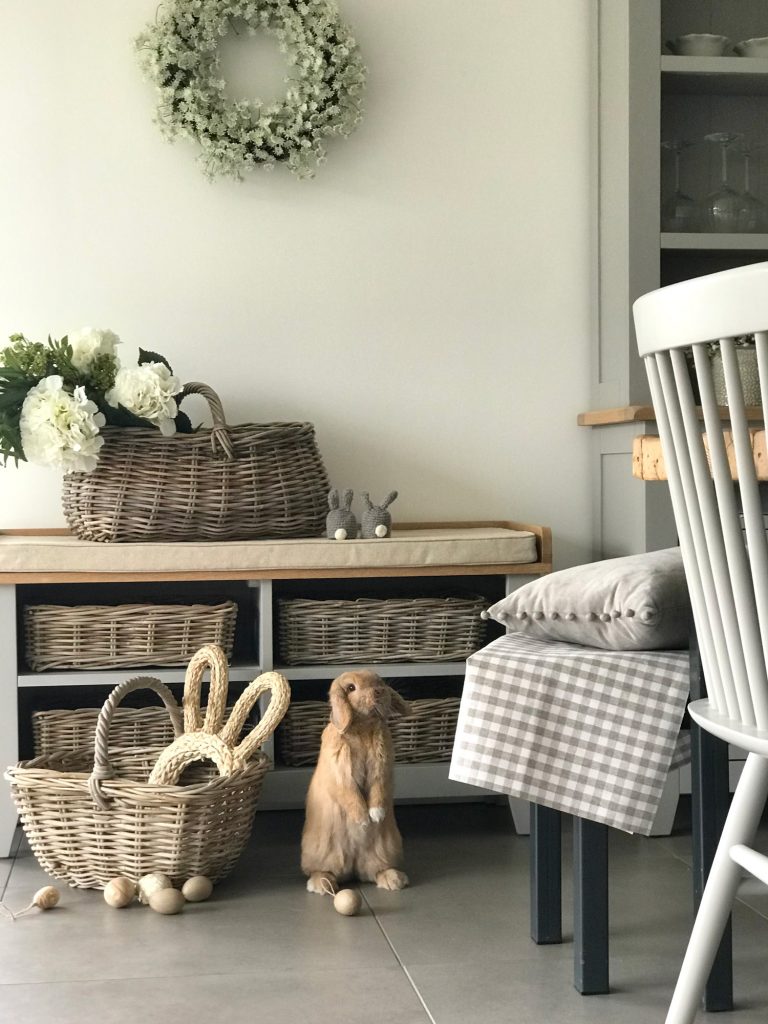 A beautiful rustic kitchen styled for Easter with a bunny and eggs.