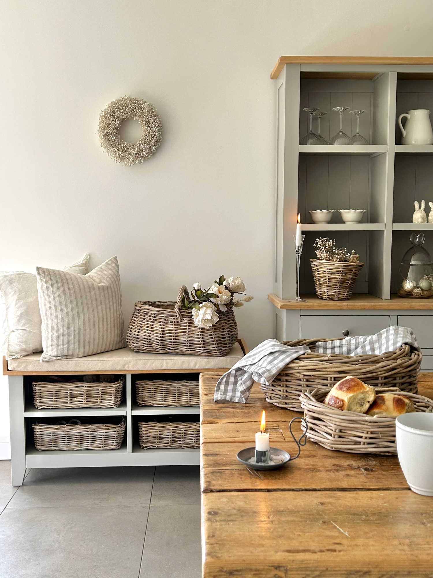 A rustic kitchen styled with rattan basket full of delicious hot cross buns.