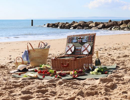 wicker picnic basket on a sunny beach