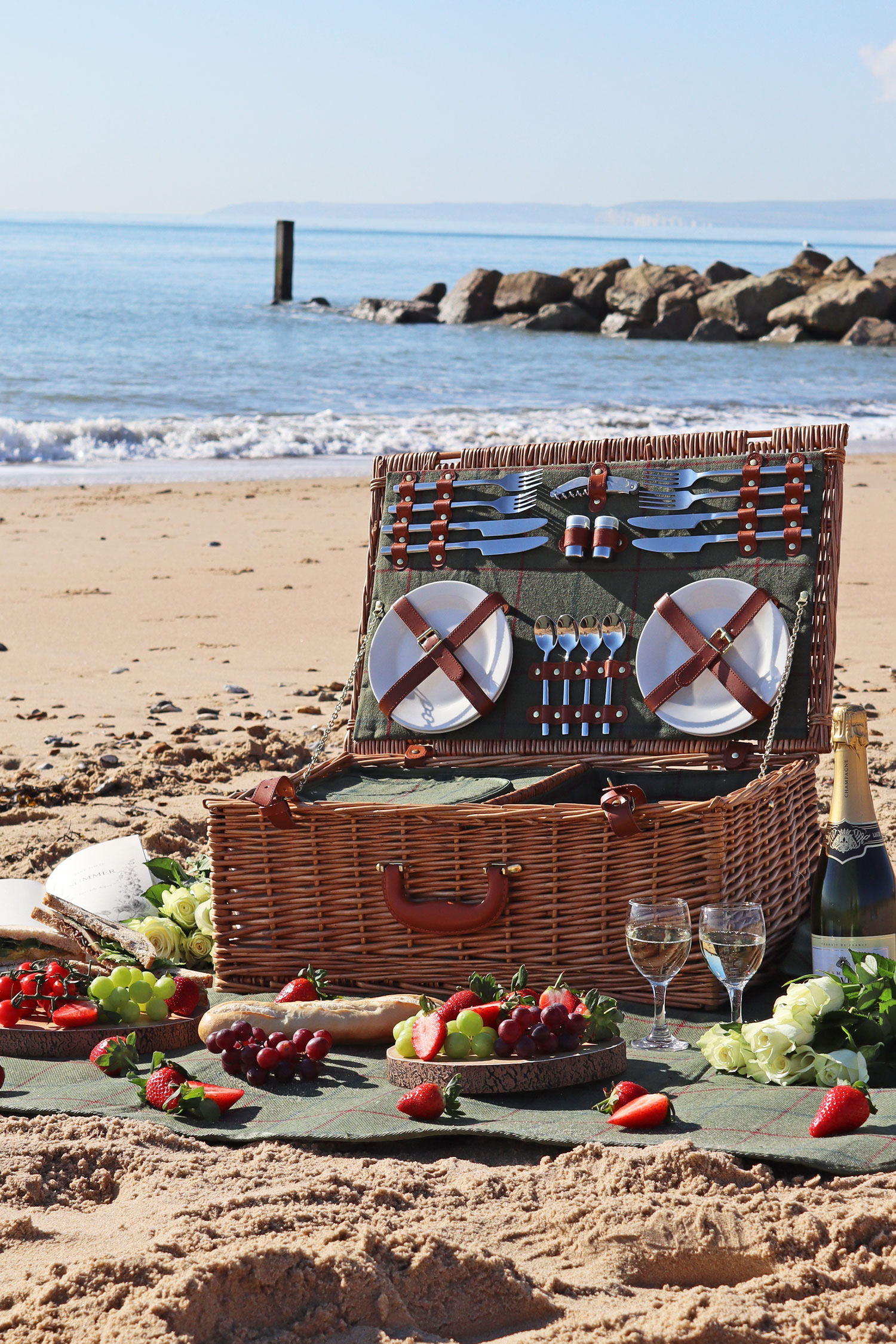 A beautiful wicker picnic basket on the beach