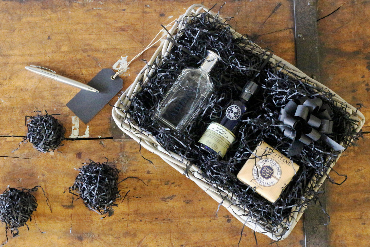 A stunning grey and buff rattan hamper basket filled with a selection of goodies perfect for Father's Day