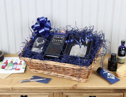 A wicker hamper filled with an assortment of Father's Day gift ideas