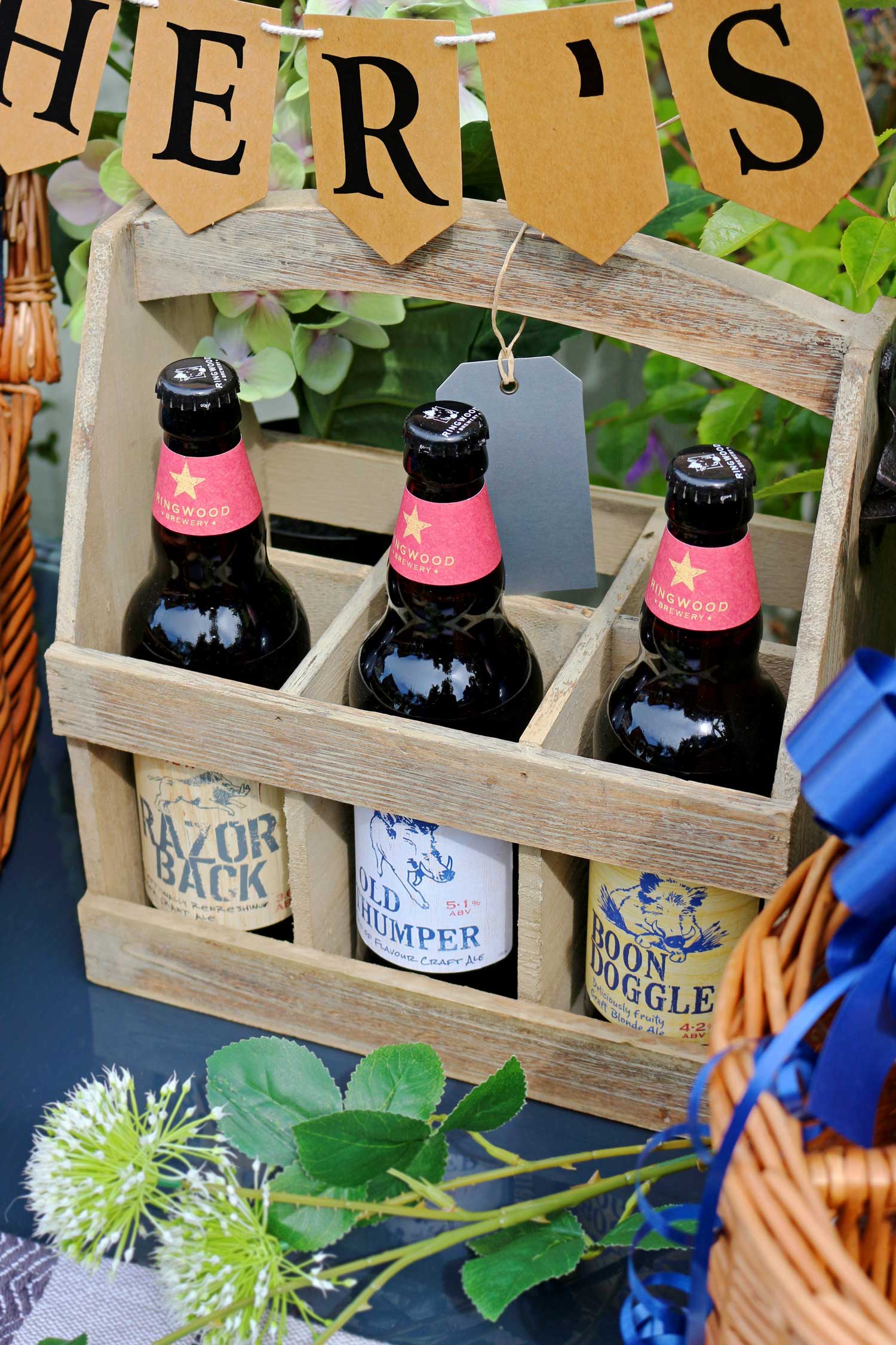 An oak effect beer bottle carrier full of a selection of local real ales