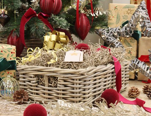 Christmas hamper filled with shred under the Christmas tree.